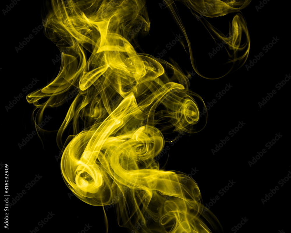 Obraz premium Yellow smoke on black background