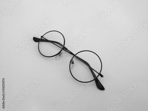 Round glasses laying on isolated white background