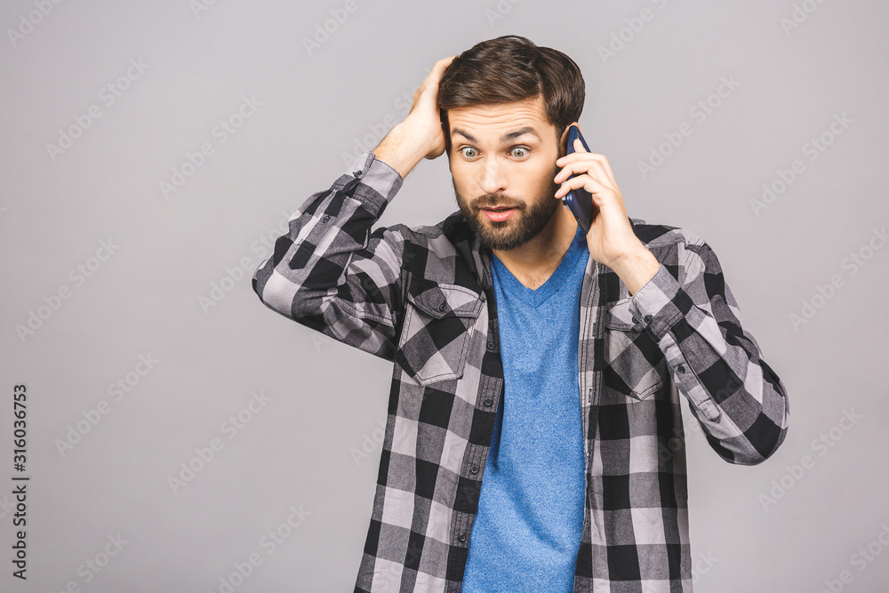 Portrait of handsome man looks shocked in smart phone, sees calendar date, finds out that he can`t manage to go on meeting. People, emotions and technology concept. Portrait of handsome man looks shocked in smart phone, sees calendar date, finds out that he can`t manage to go on meeting. People, emotions and technology concept.
