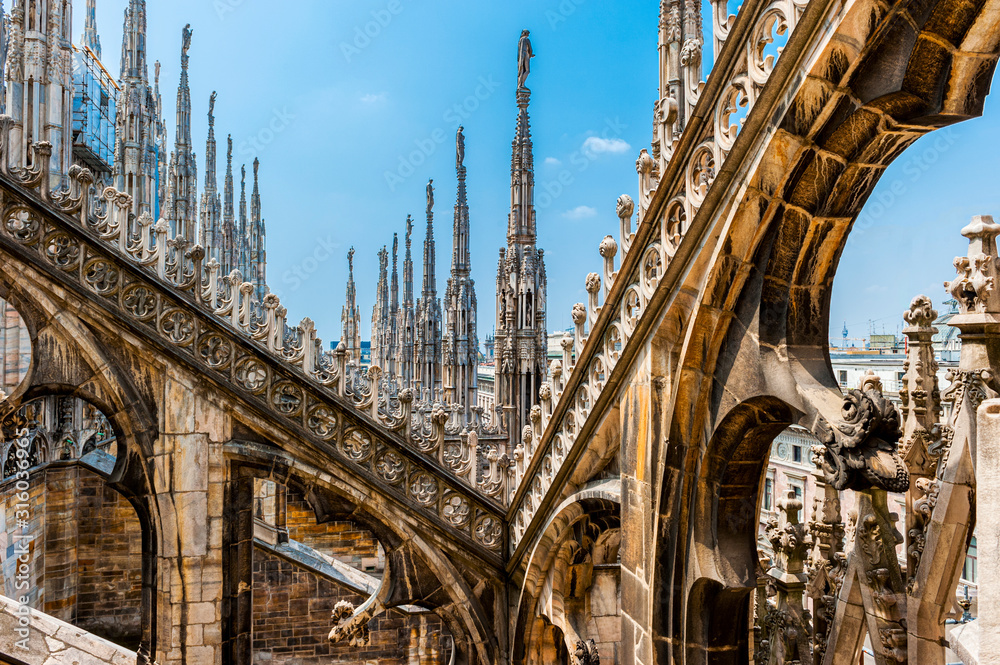 The Ornate roof top of the Duomo in Milan, Italy - obrazy, fototapety, plakaty 