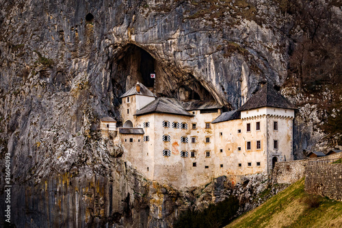 Predjama Castle built within a cave mouth in Slovenia photo