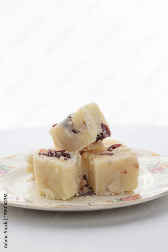 Delicious white fudge on a pretty plate with a white background Delicious white fudge on a pretty plate with a white background