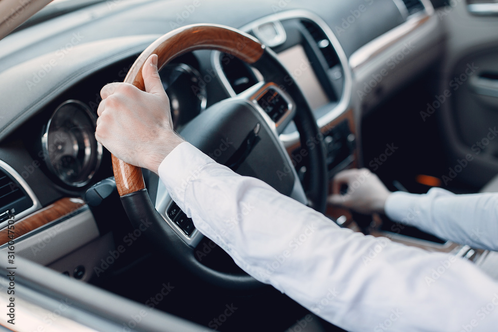 Man buying the car. Businessman in a car salon Man buying the car. Businessman in a car salon