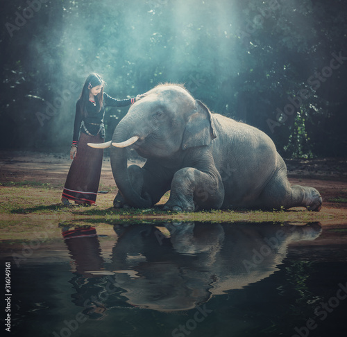 Canvas Print Beautiful girl with smiling elephant, elephant village, Surin, Thailand
