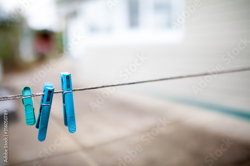 Three blue clothespins on a rope