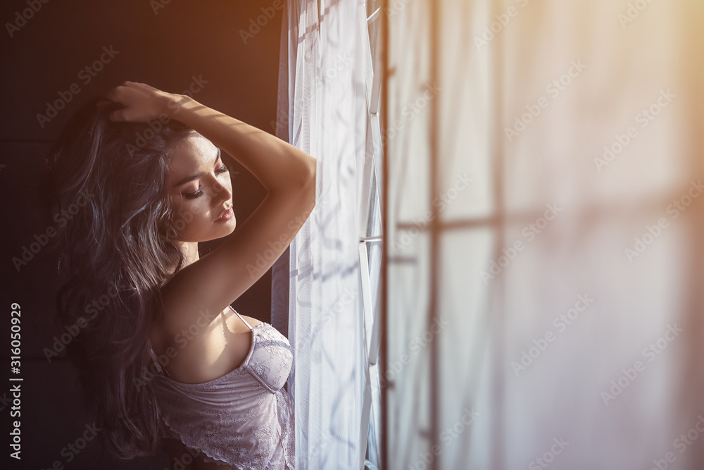 Fototapeta premium Portrait of sexy women in underwear near window. Relaxing near window