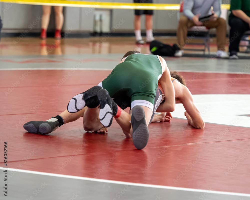 High School wrestlers competing at a wrestling meet High School wrestlers competing at a wrestling meet