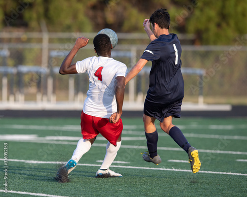 High School boy athletes making amazing plays during a soccer game