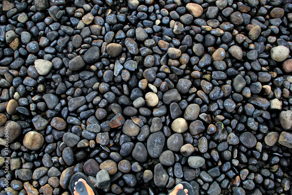 a collection of black round stones forming a pattern for background, wallpaper and web design a collection of black round stones forming a pattern for background, wallpaper and web design