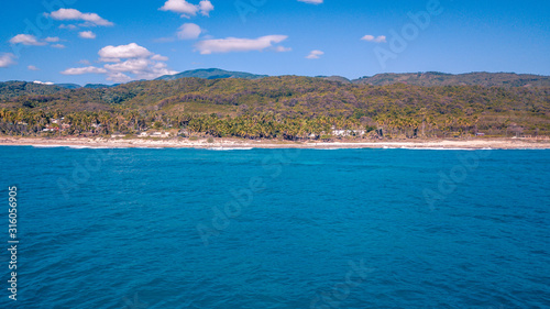 caribbean beach with mountains © Pedro