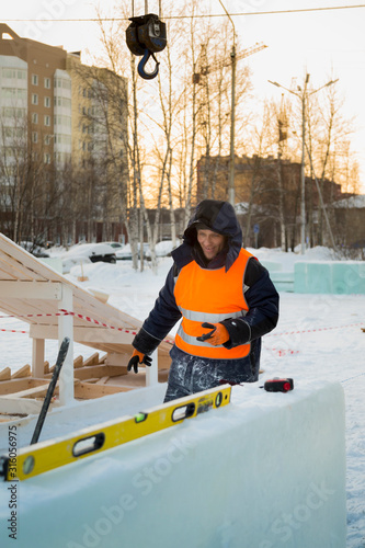 Worker at the assembly site of the ice town