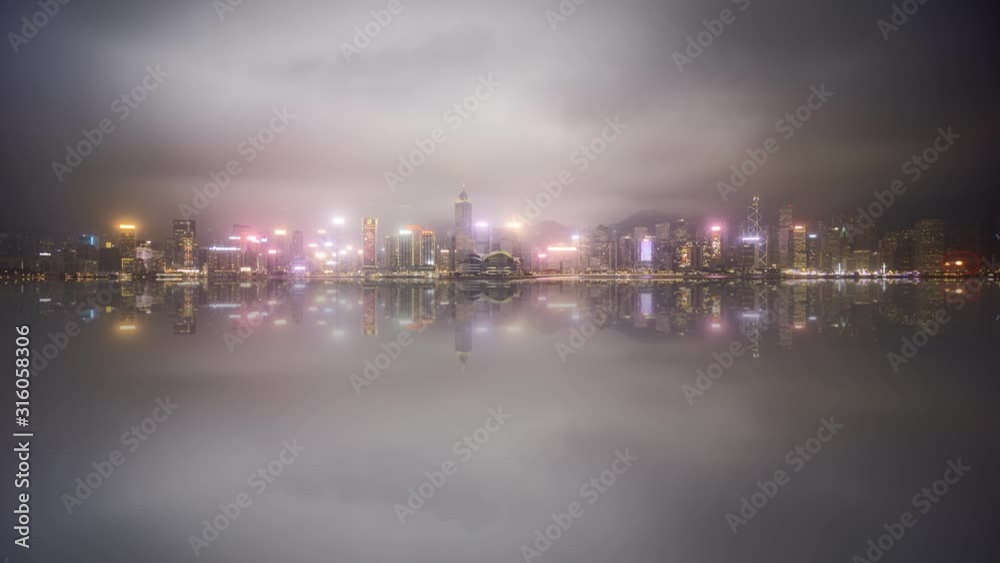 4k time lapse of sunset day to night at Hong Kong city skyline during cloudy and misty weather. 4k time lapse of sunset day to night at Hong Kong city skyline during cloudy and misty weather.
