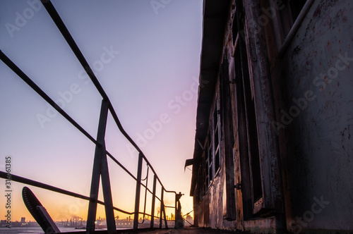 A very beautiful sunset in the sun on an old abandoned burned ship.