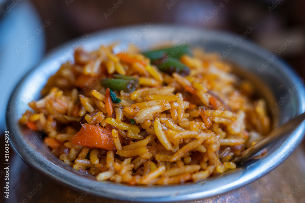 Navratan saffron biryani in metal pot on wooden background, top view, close up. Indian cuisine Navratan saffron biryani in metal pot on wooden background, top view, close up. Indian cuisine