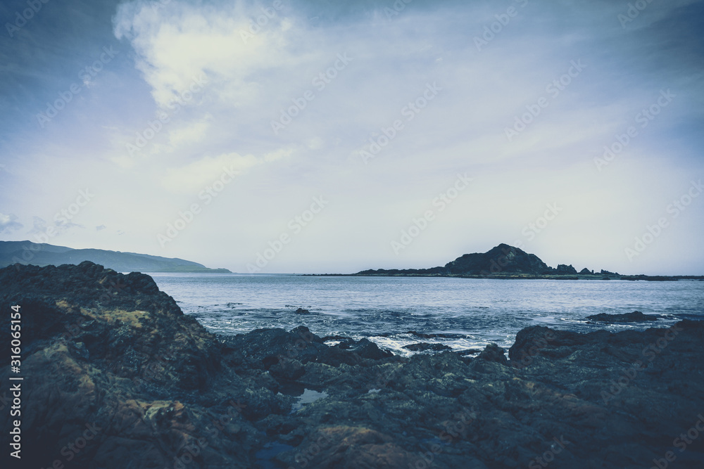 beach rock and stone to show with beach in background