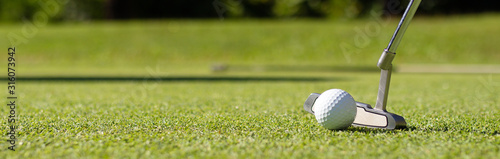 Close Up of Golf club and ball in grass.