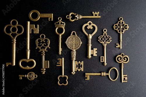 Bronze keys on black background antique key still life photo