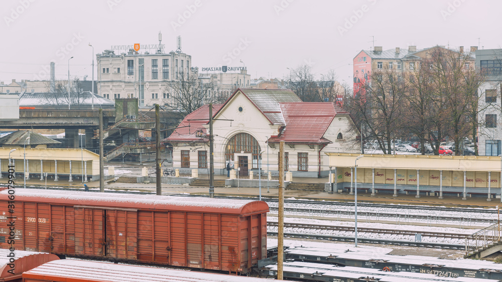 City Riga, Latvia. Railway station in the fog with wagons and rails. Visible snow.