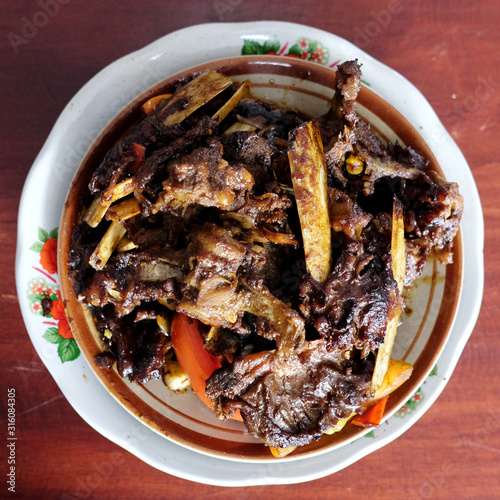 Tengkleng Kambing Pak manto, Solo, Central Java, Indonesia. Traditional Indonesian spicy food made from the bones of goat. photo