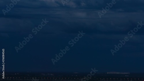 Big flash of lightning over a horizon in the rain