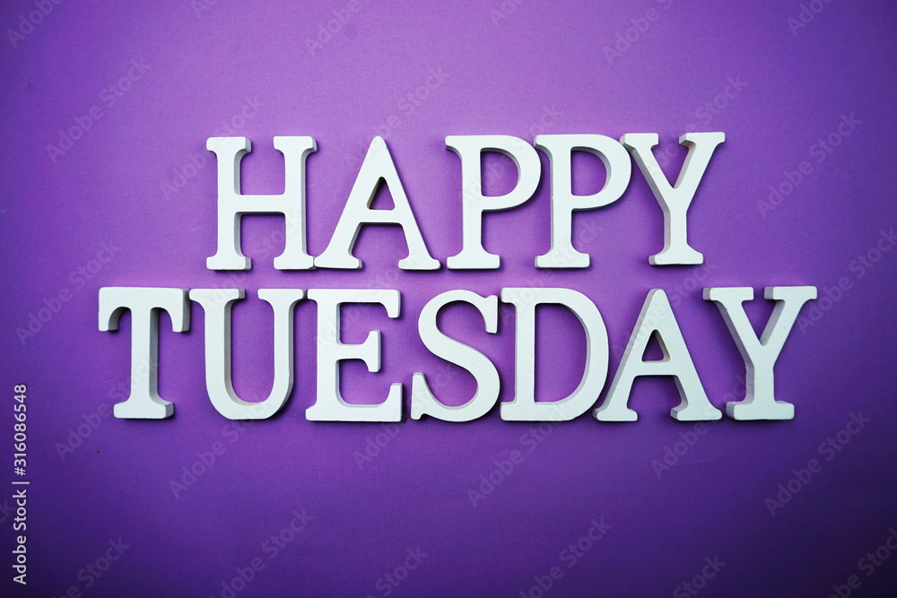 Fototapeta premium Happy Tuesday wooden letter alphabet on purple background