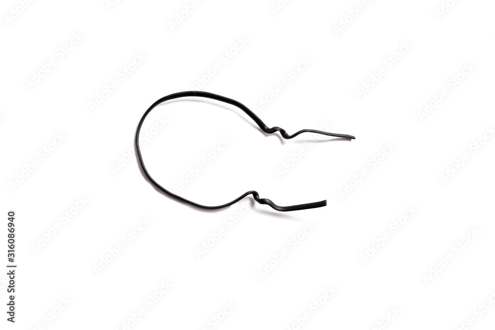 Black used piece of wire for pulling electric cables and other things on a white background isolate. Black plastic coated wire tie. Cable flexible tie tools for packing. Top view.