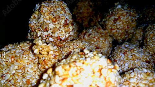 Closeup HD video of amarnath seed or sesame seed sweet, also known as til ka laddo, Indian sweet and healthy food. photo