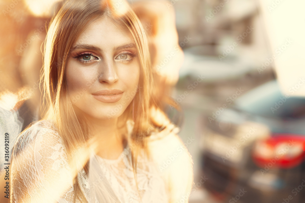 Attractive young woman daydreaming and looking through the window