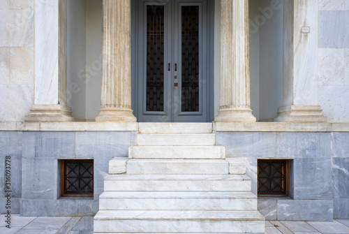 Impressive entrance with marble columns  classical architecture building detail.