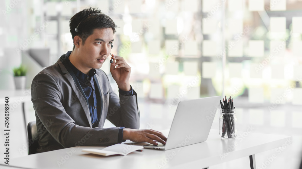 Close up view of male customer service giving advice customer by using headset Close up view of male customer service giving advice customer by using headset