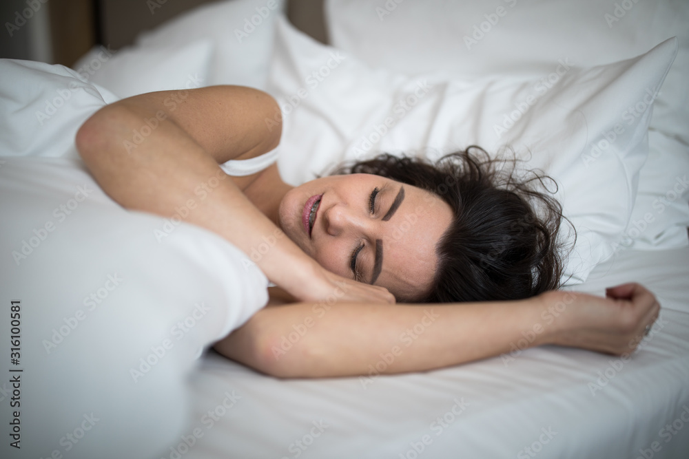 Beautiful young woman sleeping on bed at bedroom Beautiful young woman sleeping on bed at bedroom