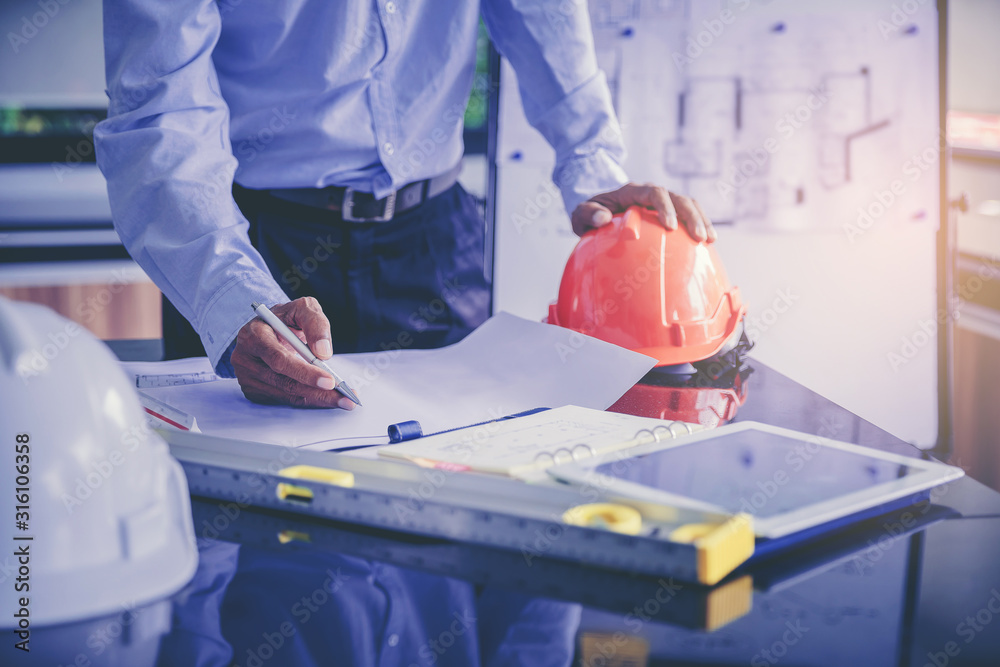 Architect inspect the blueprints at a modern construction site, Engineers in mechanical factory reading instructions Architect inspect the blueprints at a modern construction site, Engineers in mechanical factory reading instructions
