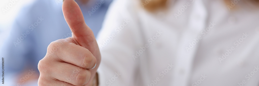 Female hand showing ok or approval sign with thumb up in creative people office during conference. High level and quality service job offer excellent education advisor serious business concept okay Female hand showing ok or approval sign with thumb up in creative people office during conference. High level and quality service job offer excellent education advisor serious business concept okay
