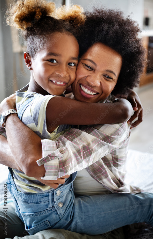 Portrait of a joyful mother and her daughter smiling and hugging - obrazy, fototapety, plakaty 