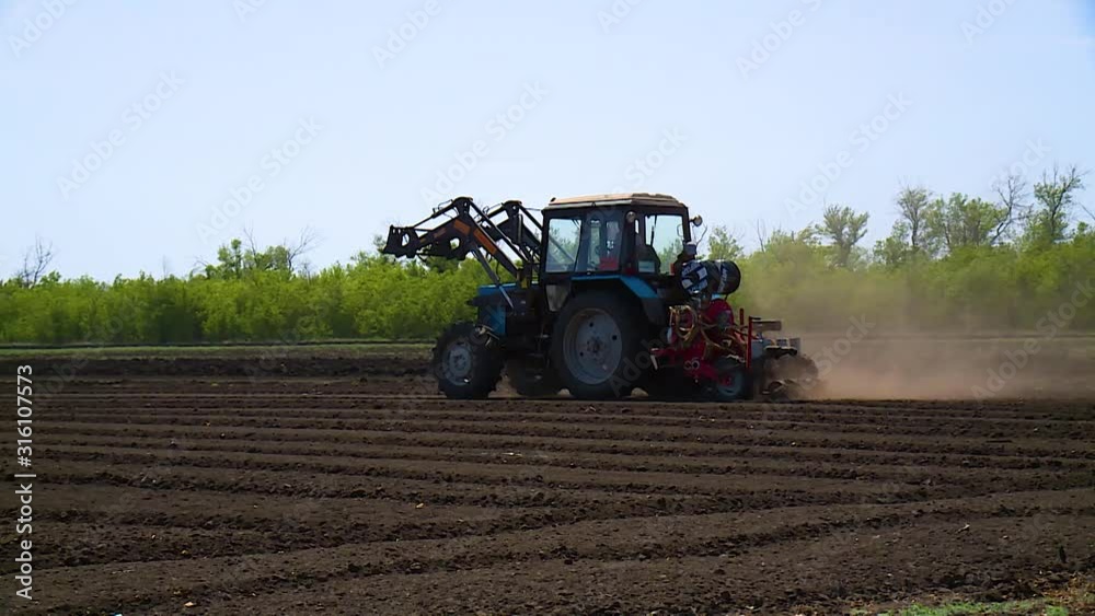 Tractor plows a field for seedlings Tractor plows a field for seedlings