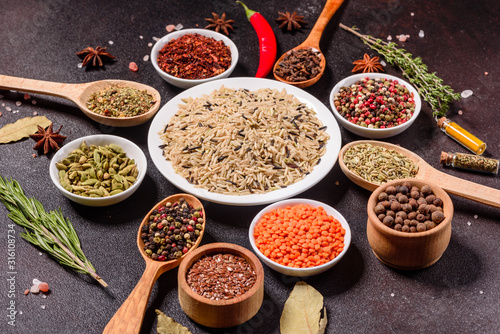 A set of spices and herbs. Indian cuisine. Pepper  salt  paprika  basil and other on a dark background
