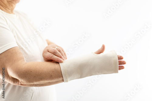 Woman wearing bandage wrist support © bymandesigns