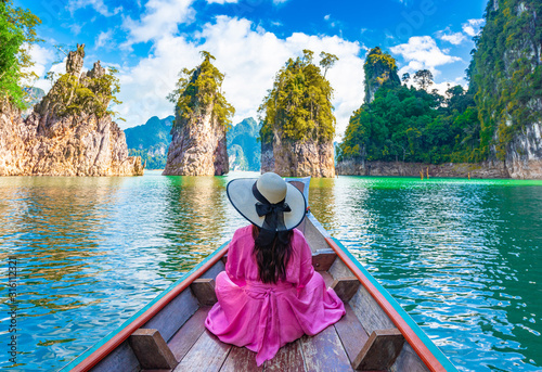 Asian woman sitting on boat in Ratchaprapha dam Khao sok national park at suratthani,Thailand. photo