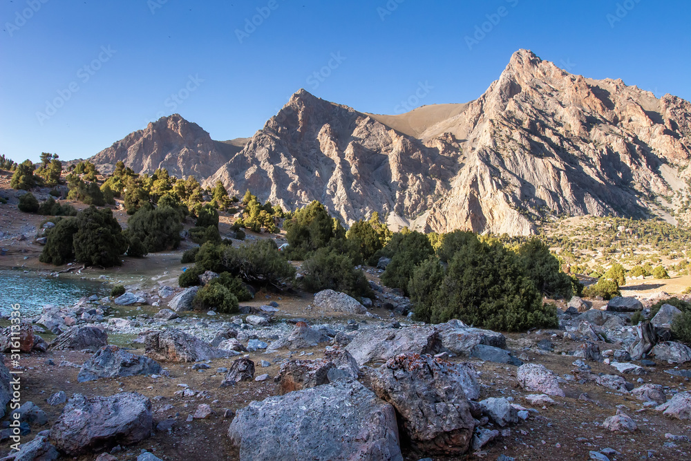 Landscape of sunrise in mountains. Camping near by lake, placing among mountains Landscape of sunrise in mountains. Camping near by lake, placing among mountains