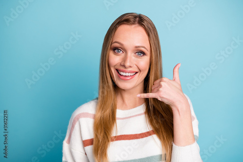 Photo of cheerful positive cute pretty sweet woman smile toothy gesturing telephone with fingers showing opportunity to ring her up isolated pastel blue color background