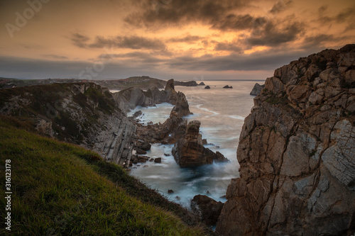 Cliffs and rocks formations of the Costa Quebrada at sunset. Cantabria, Spain.