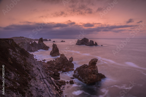 Cliffs and rocks formations of the Costa Quebrada at sunset. Cantabria, Spain.