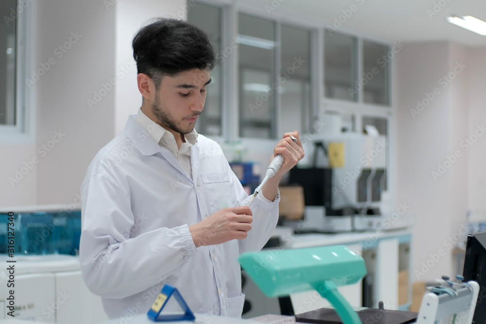 Man in white uniform in laboratory work on analize. Man in white uniform in laboratory work on analize.