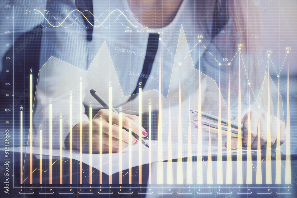 Double exposure of hands making notes with forex chart huds. Stock market concept. Double exposure of hands making notes with forex chart huds. Stock market concept.