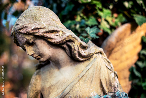 Obraz na płótnie A fragment of ancient sculpture angel in the old cemetery. Symbol of love, invisible forces, purity, enlightenment, ministry, salvation. Chariot. w salonie