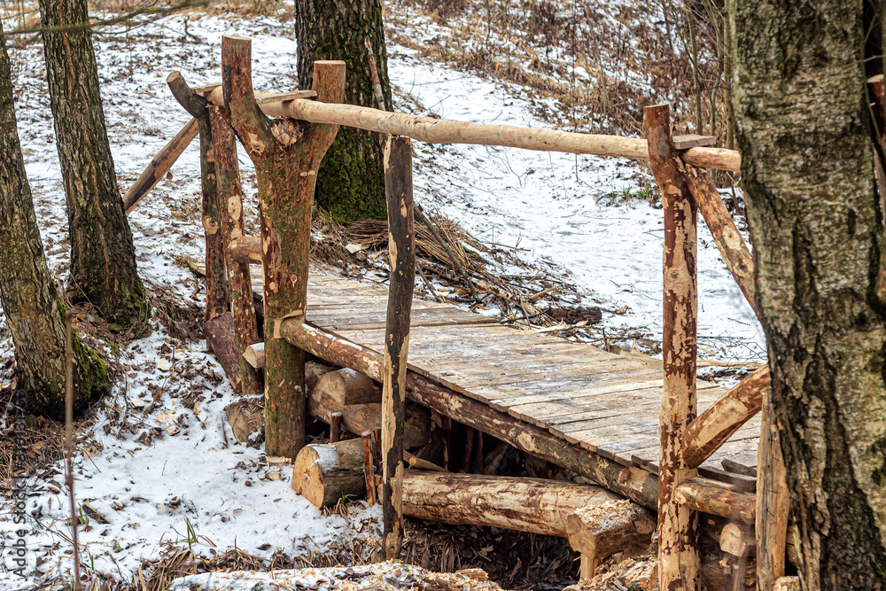 Wooden bridge over a forest stream Wooden bridge over a forest stream