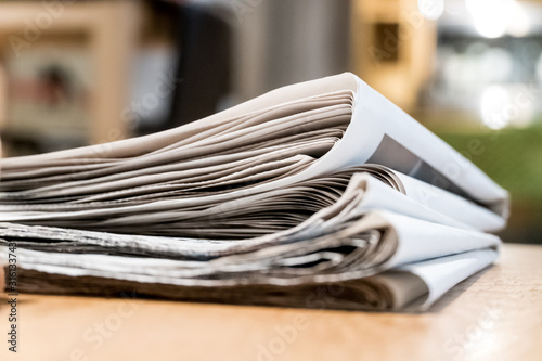 Stack of newspapers on a desk