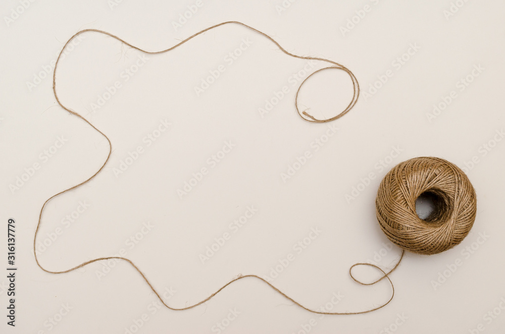 Fototapeta premium Hemp cord, jute twine on white paper backgound