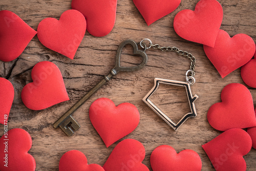 House key with home keyring on old wood table background
