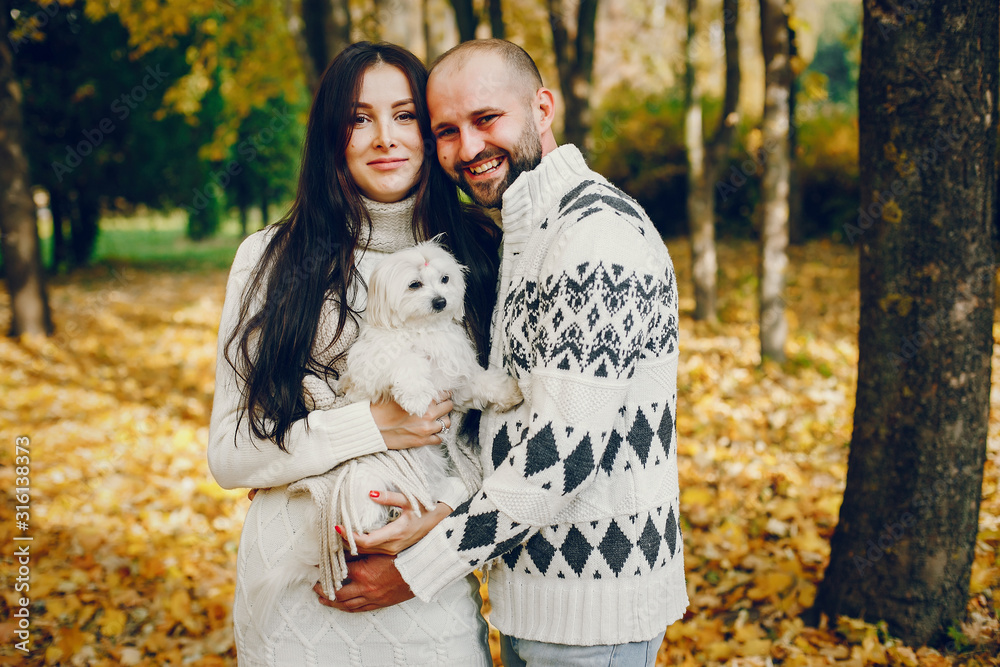 Couple in a park. Brunette in a white sweater. Man with a beard Couple in a park. Brunette in a white sweater. Man with a beard